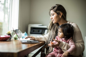 Woman working from home with young child